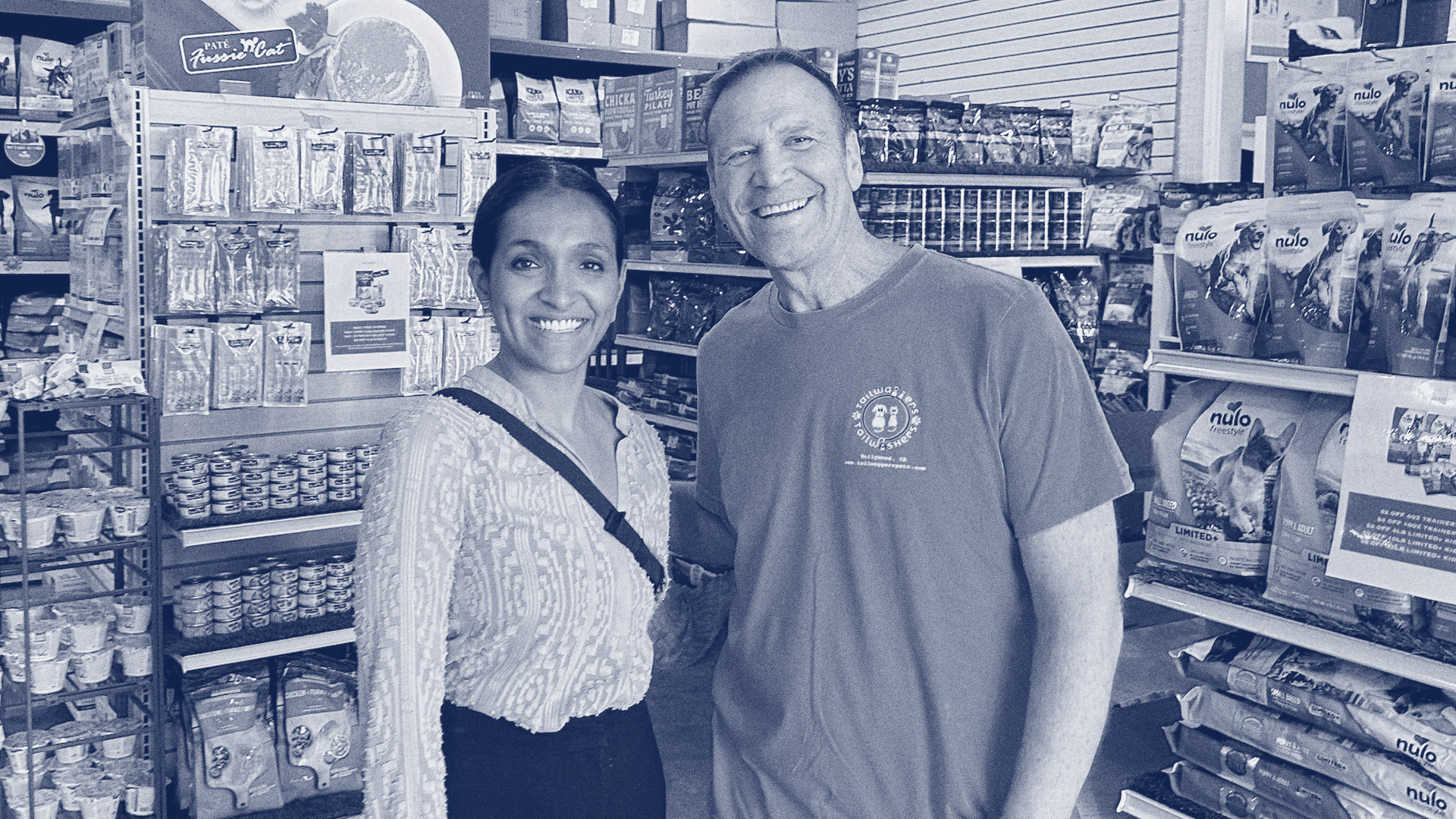 Nithya Raman with small business roman at grocery store