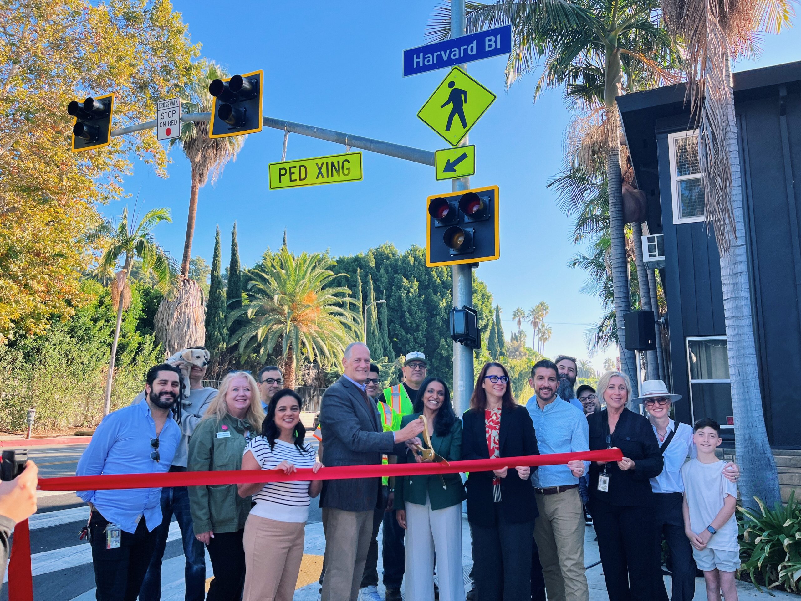 Councilmember Nithya Raman, Congreswoman Laura Friedman, leadership from LADOT and BSS, and community members cut ribbon on new crosswalk